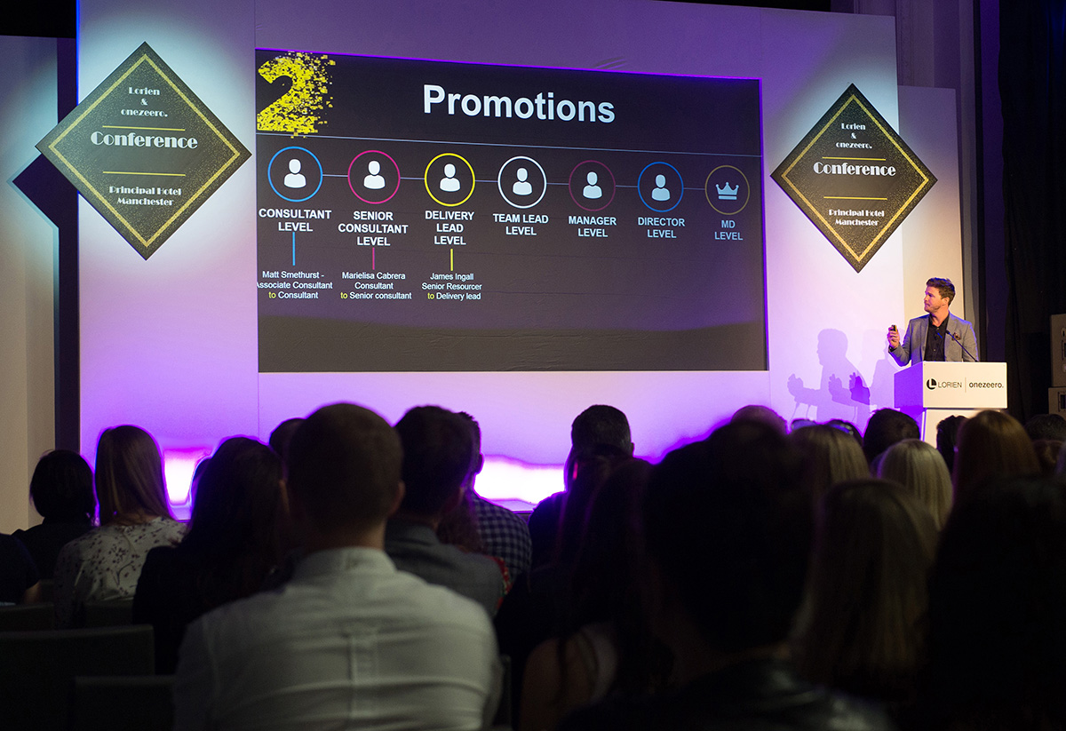 Speaker discussing company targets at a conference