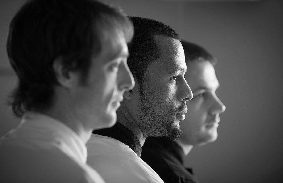 Profile of three waiters